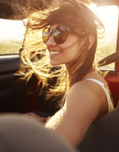 A young woman smiling, happy from healthy sleep.