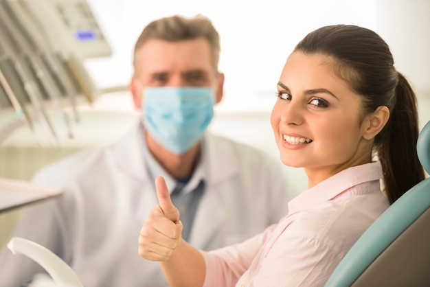 A laughing gas dentist with nitrous oxide near you, working with a smiling patient.