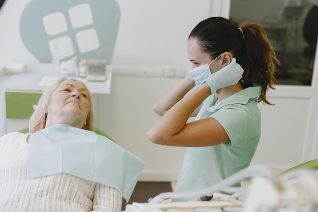 Dentist preparing for a dental sedation procedure while reassuring an older patient.