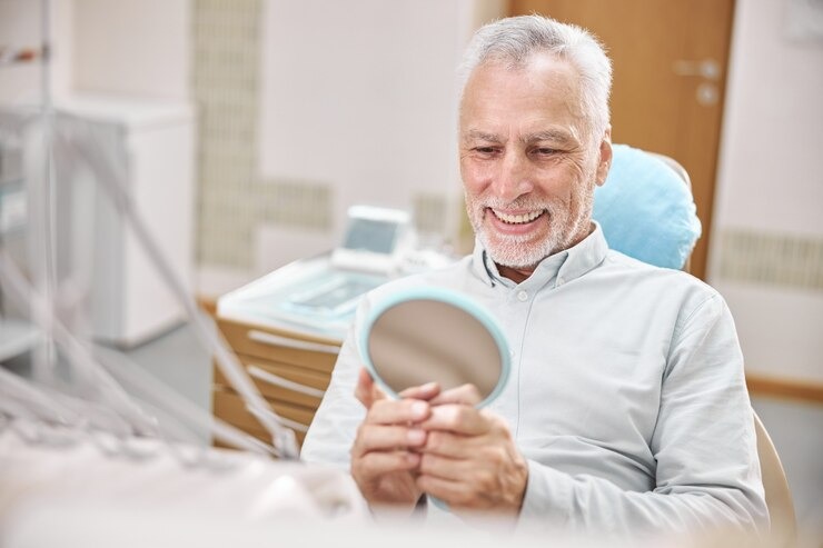 Patient viewing the mirror and happy with his crown tooth.