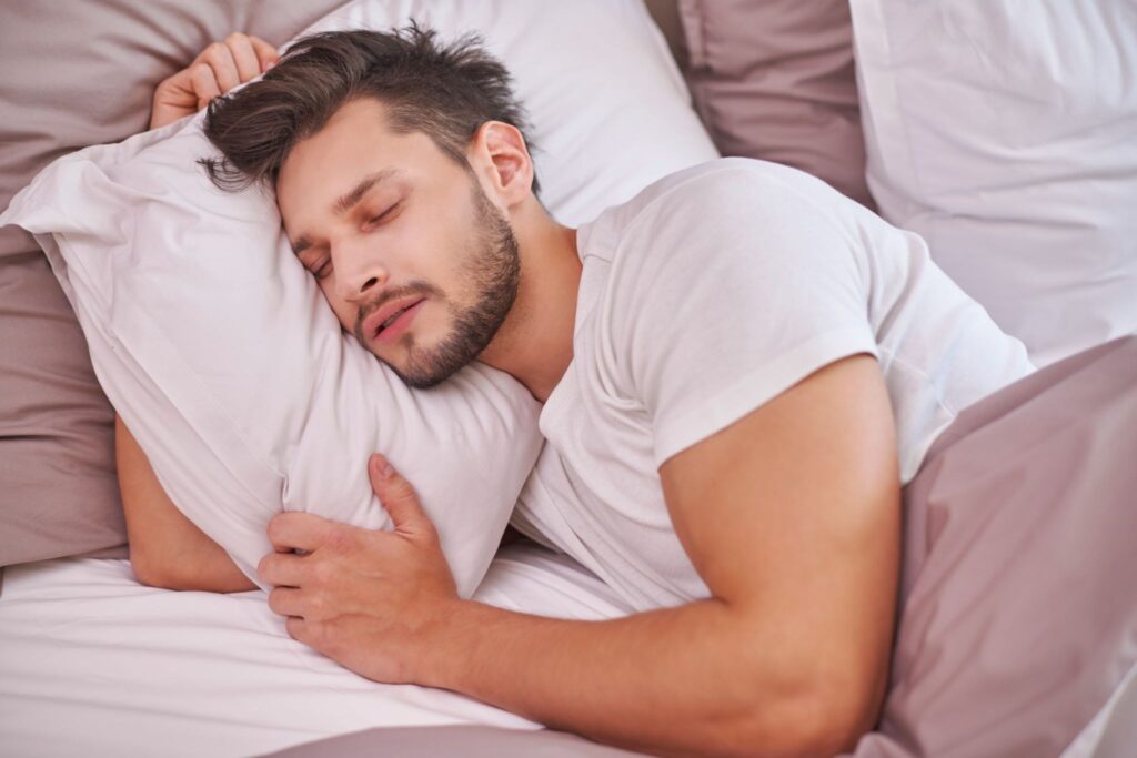 A person trying to stop snoring causes by sleeping on his side as a snoring remedy.
