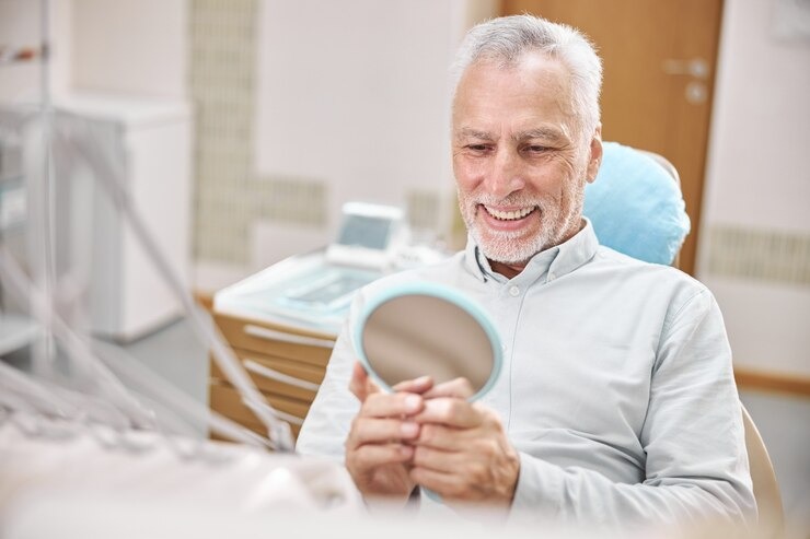 Man smiling after dental mini implant teeth replacement.