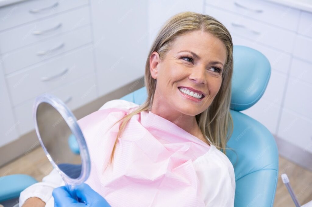 Patient smiling after a dental mini implant procedure, looking satisfied with her tooth replacement.