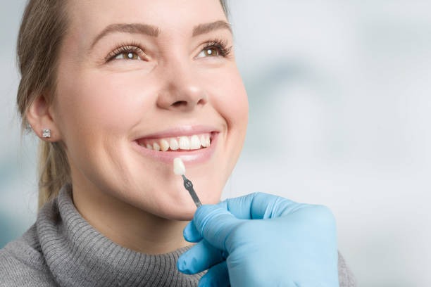 Patient learning what veneers are from a cosmetic dentist with a veneers cost consultation